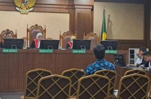 Ahli akuntansi forensik dari Komisi Pemberantasan Korupsi (KPK), Miftakh Aulani Rahman, membeberkan temuan aliran dana yang diduga berasal dari praktik pemerasan dalam pengurusan Rencana Penggunaan Tenaga Kerja Asing (RPTKA) di lingkungan Kementerian Ketenagakerjaan (Kemnaker). Nilai dana yang teridentifikasi di rekening penampungan disebut mencapai Rp135 miliar. Miftakh dihadirkan sebagai ahli oleh Jaksa Penuntut Umum (JPU) dalam persidangan delapan terdakwa, yakni Suhartono selaku Dirjen Binapenta dan PKK periode 2020–2023; Haryanto yang pernah menjabat Direktur Pengendalian Penggunaan Tenaga Kerja Asing (PPTKA) 2019–2024 sekaligus Dirjen Binapenta dan PKK 2024–2025; Wisnu Pramono selaku Direktur PPTKA 2017–2019; Devi Angraeni yang menjabat Direktur PPTKA 2024–2025; Gatot Widiartono (Koordinator Analisis dan PPTKA 2021–2025); Putri Citra Wahyoe (Petugas Hotline RPTKA 2019–2024 dan Verifikator Pengesahan RPTKA 2024–2025); Jamal Shodiqin (Analis TU Direktorat PPTKA 2019–2024 dan Pengantar Kerja Ahli Pertama 2024–2025); serta Alfa Eshad (Pengantar Kerja Ahli Muda Kemnaker 2018–2025). Dalam sidang di Pengadilan Tindak Pidana Korupsi Jakarta Pusat, Kamis (26/2/2026), jaksa mempertanyakan hasil analisis terhadap rekening koran yang diperiksa. Jaksa menyinggung kemungkinan adanya anomali maupun indikasi penambahan harta. Menjawab pertanyaan tersebut, Miftakh menyampaikan bahwa total dana yang dihitung timnya mencapai Rp135 miliar. “Secara keseluruhan hasil perhitungan kami sebesar Rp135 miliar, Yang Mulia,” ujarnya di hadapan majelis hakim. Ia menjelaskan, tim forensik menelusuri sejumlah rekening bank yang diduga berfungsi sebagai penampung dana dari agen-agen pengurusan RPTKA. Pola penerimaan dana, kata dia, terbagi dalam dua kelompok. Kelompok pertama berasal dari agen berskala kecil yang mengajukan kurang dari 50 RPTKA dan menyetorkan dana melalui transfer bank. Dari jalur ini, tercatat sekitar Rp60 miliar masuk ke rekening yang dikelola sejumlah terdakwa, antara lain Putri Citra Wahyoe, Alfa Eshad, Jamal Shodiqin, Gatot Widiartono, dan Devi Angraeni. Sementara kelompok kedua berasal dari agen besar yang menyerahkan uang secara tunai. Berdasarkan perhitungan tim ahli, nilai uang tunai yang diberikan kepada Direktur PPTKA saat itu—yakni Wisnu Pramono dan Haryanto—mencapai Rp74,67 miliar. Dalam surat dakwaan, jaksa KPK menyebut total dugaan pemerasan mencapai Rp135,2 miliar. Praktik tersebut diduga terjadi di Direktorat Jenderal Pembinaan Penempatan Tenaga Kerja dan Perluasan Kesempatan Kerja (Binapenta dan PKK) Kemnaker. Rincian dalam dakwaan menyebut Suhartono diduga menerima Rp460 juta pada periode 2020–2023. Haryanto disebut memperoleh Rp84,7 miliar serta satu unit mobil Innova Reborn bernomor polisi B 1354 HKY sepanjang 2018–2025. Wisnu Pramono didakwa menerima Rp25,1 miliar dan satu unit sepeda motor Vespa Primavera bernomor polisi B 4880 BUQ pada 2017–2019. Adapun Devi Angraeni didakwa menerima Rp3,25 miliar; Gatot Widiartono Rp9,47 miliar; Putri Citra Wahyoe Rp6,39 miliar; Alfa Eshad Rp5,23 miliar; serta Jamal Shodiqin Rp551,1 juta dalam kurun waktu 2017–2025.